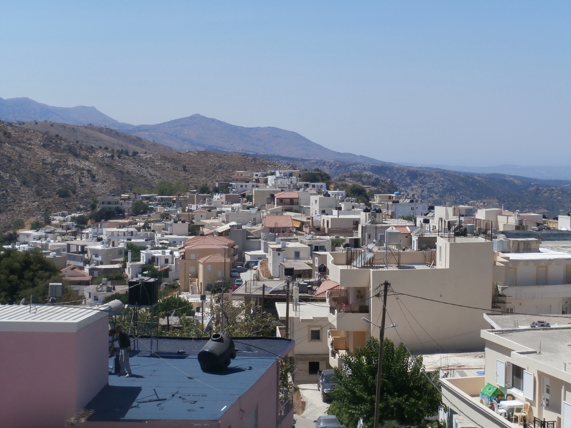 View across Anogeia village with stone buildings and mountain light