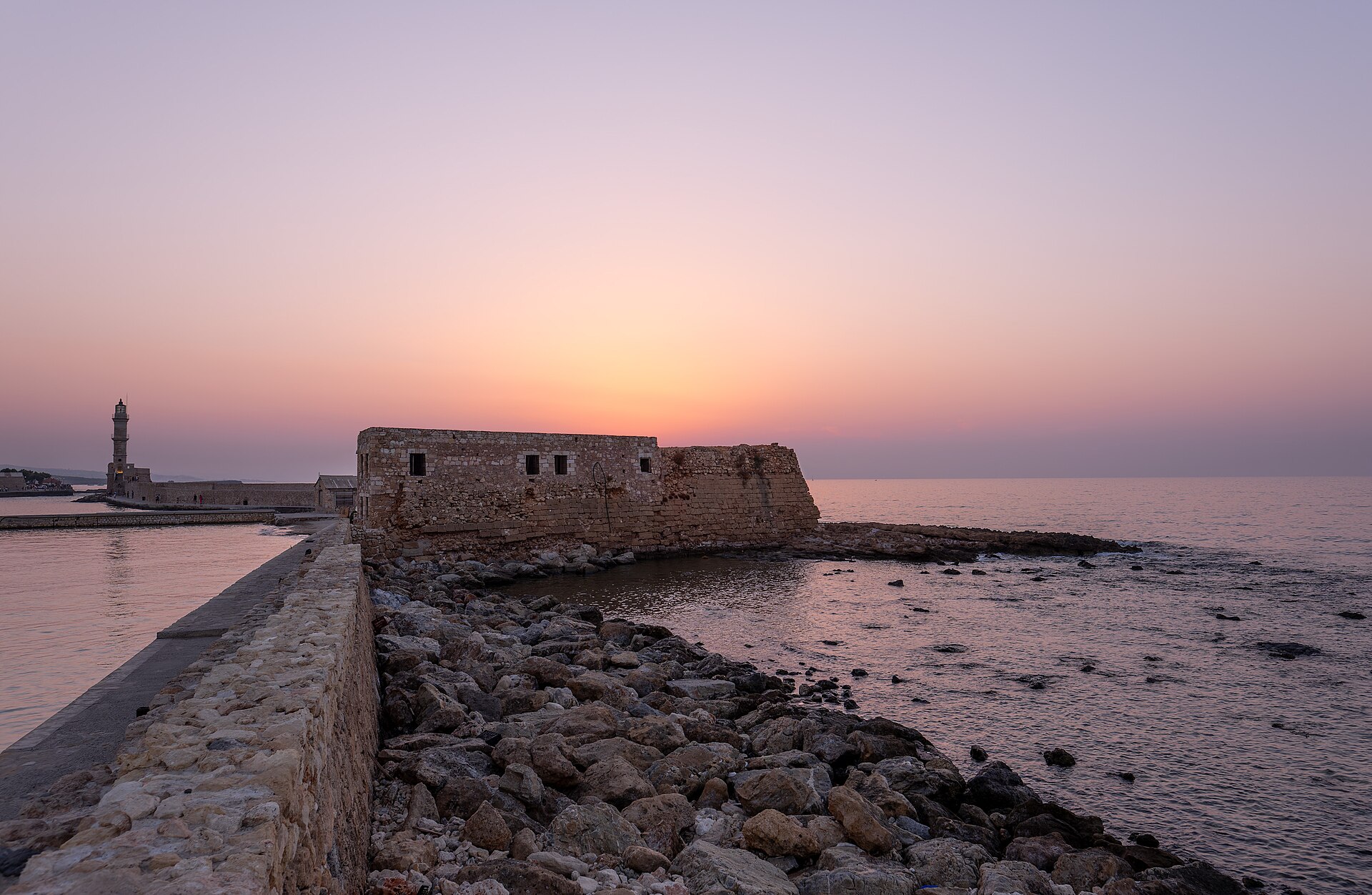 The old Venetian harbour and lighthouse of Chania at sunset