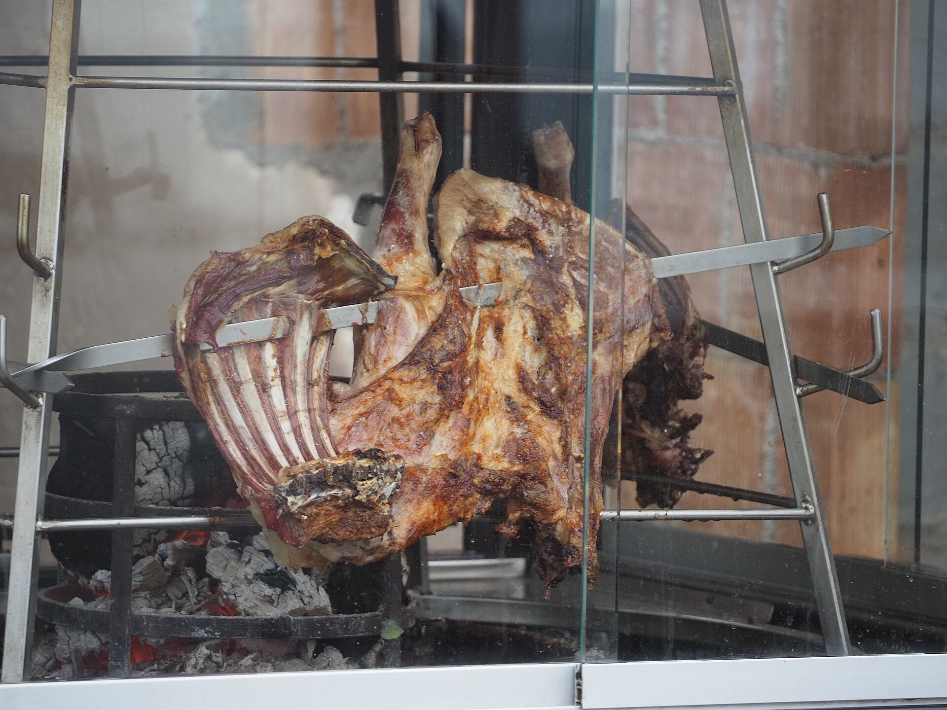 Antikristo — lamb cooked the traditional Cretan way in Axos, Mylopotamos, the meat arranged upright on skewers around an open wood fire.