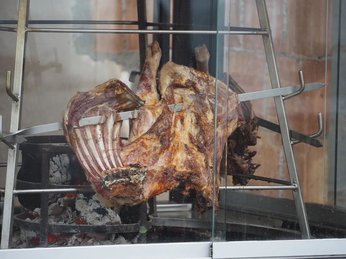 Antikristo — lamb cooked the traditional Cretan way in Axos, Mylopotamos, the meat arranged upright on skewers around an open wood fire.