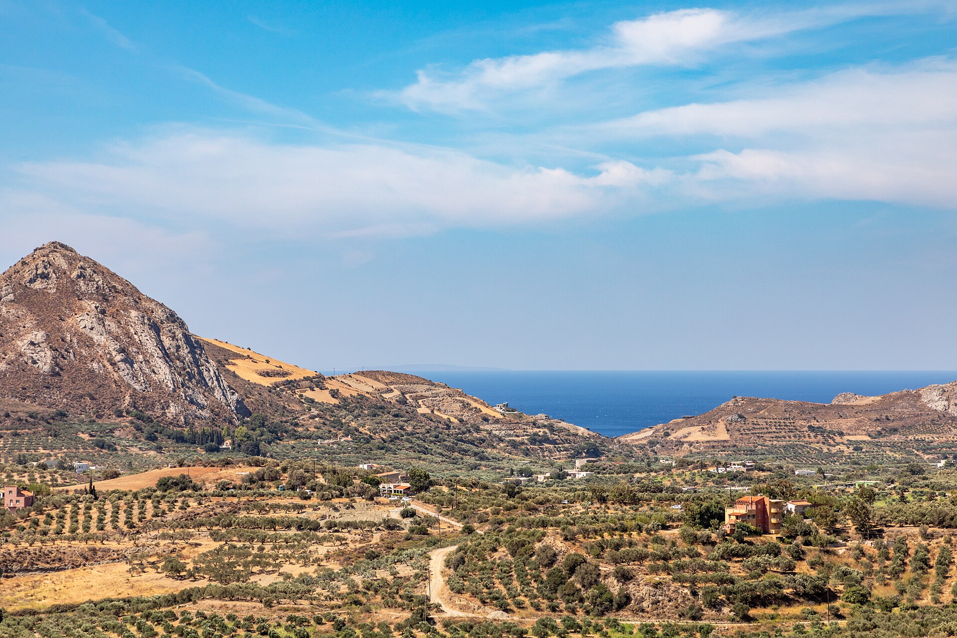 A coastal plain near Asomatos village in Crete, backed by bare limestone mountains that rise sharply from the sea