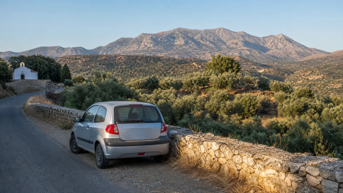 A compact car on a village road in Crete
