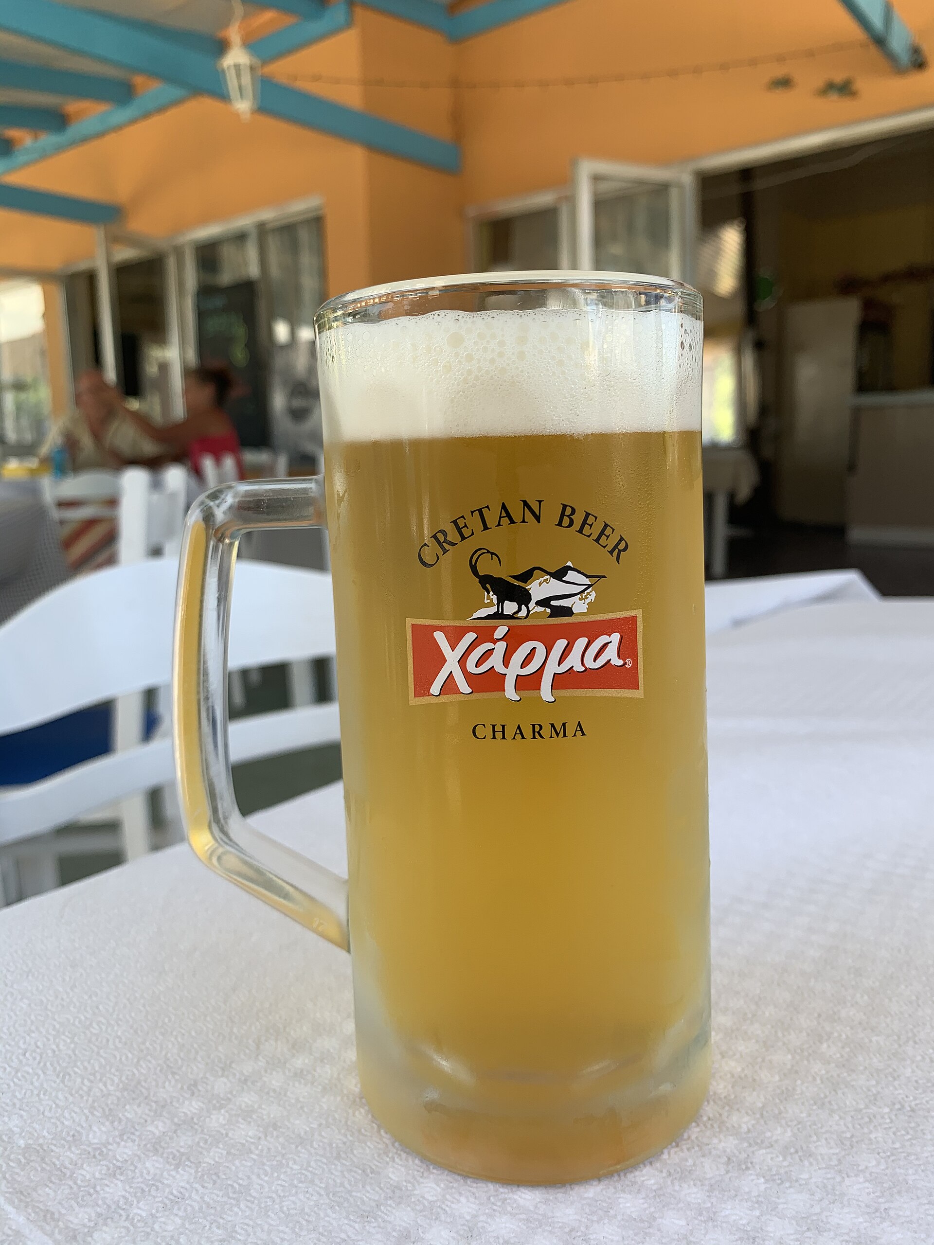 A frosted mug of Charma, the Cretan Brewery beer, on a taverna table in Crete.