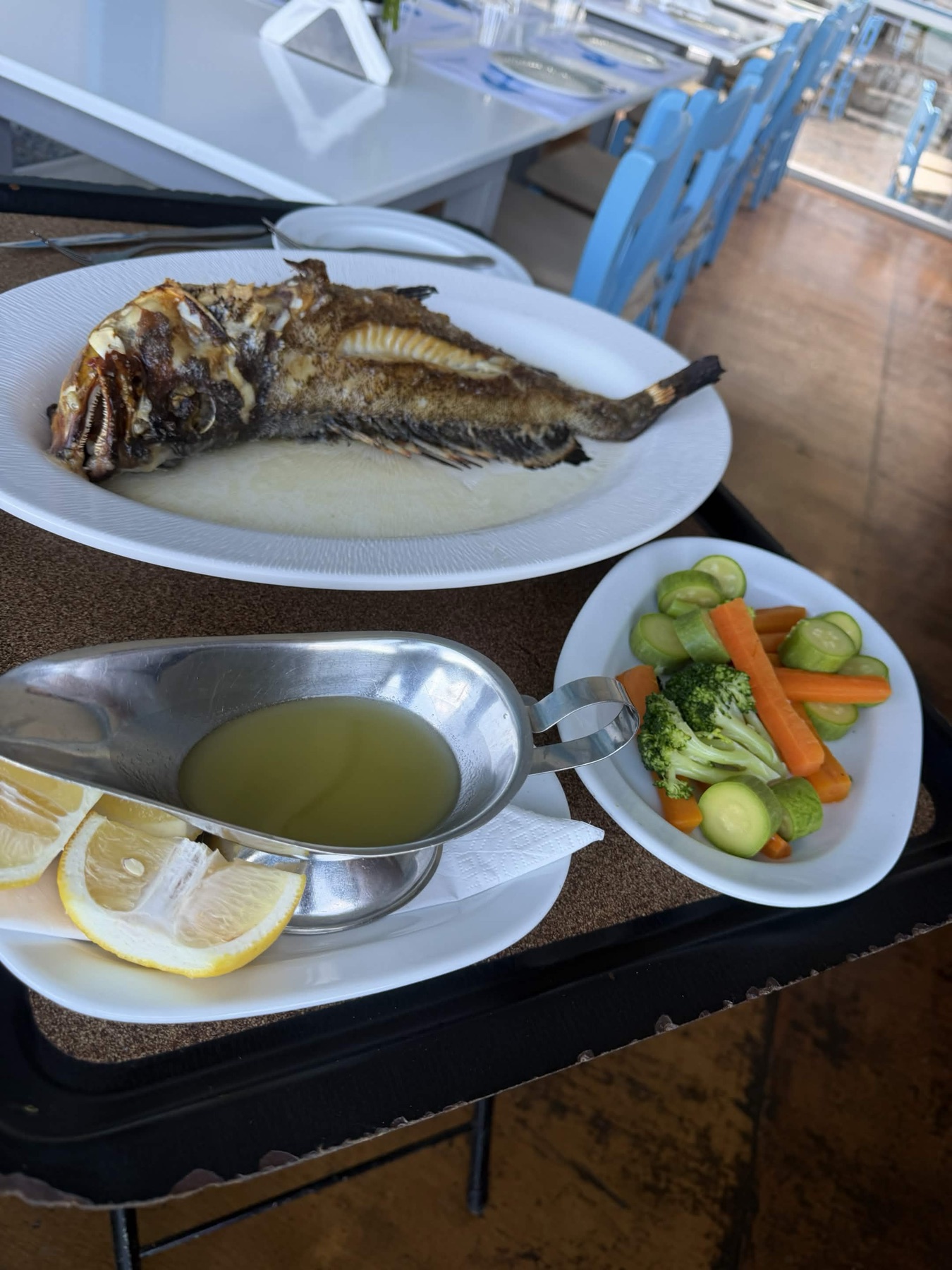 Whole rofos with lemon, sauce and vegetables at Giovanni.