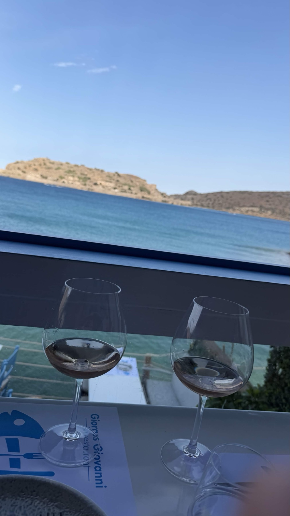 Two glasses of rosé at Giovanni with the sea beyond.