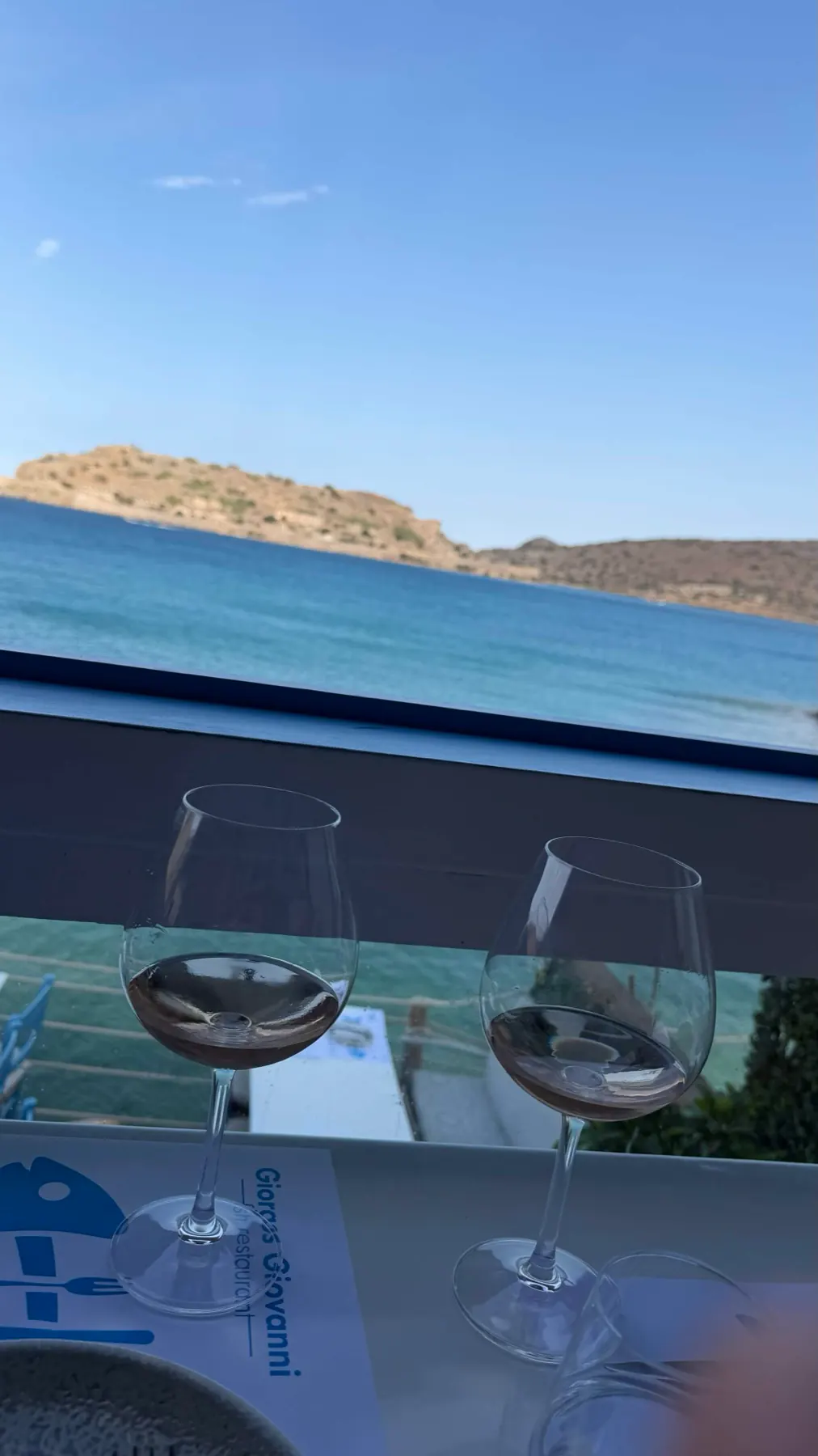 Two glasses of rosé at Giovanni with the sea beyond.