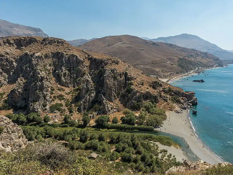 Preveli from above: a river lined with palm trees, the beach and the sea.