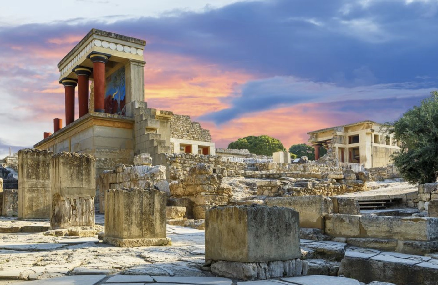 Stone ruins at Knossos under a warm sky