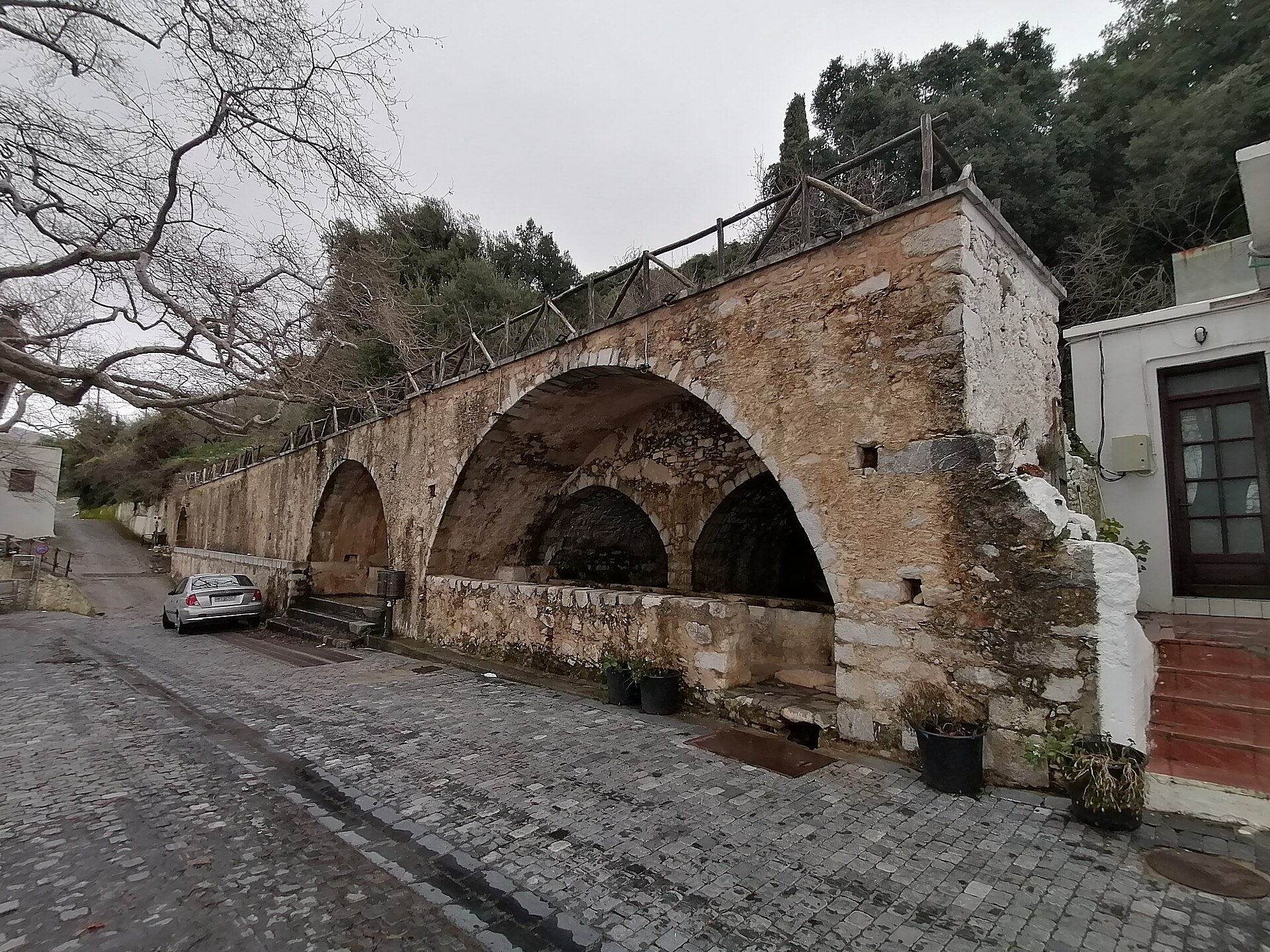 The large stone spring fountain (Megali Vrysi) at Krasi, water running from spouts into the basin