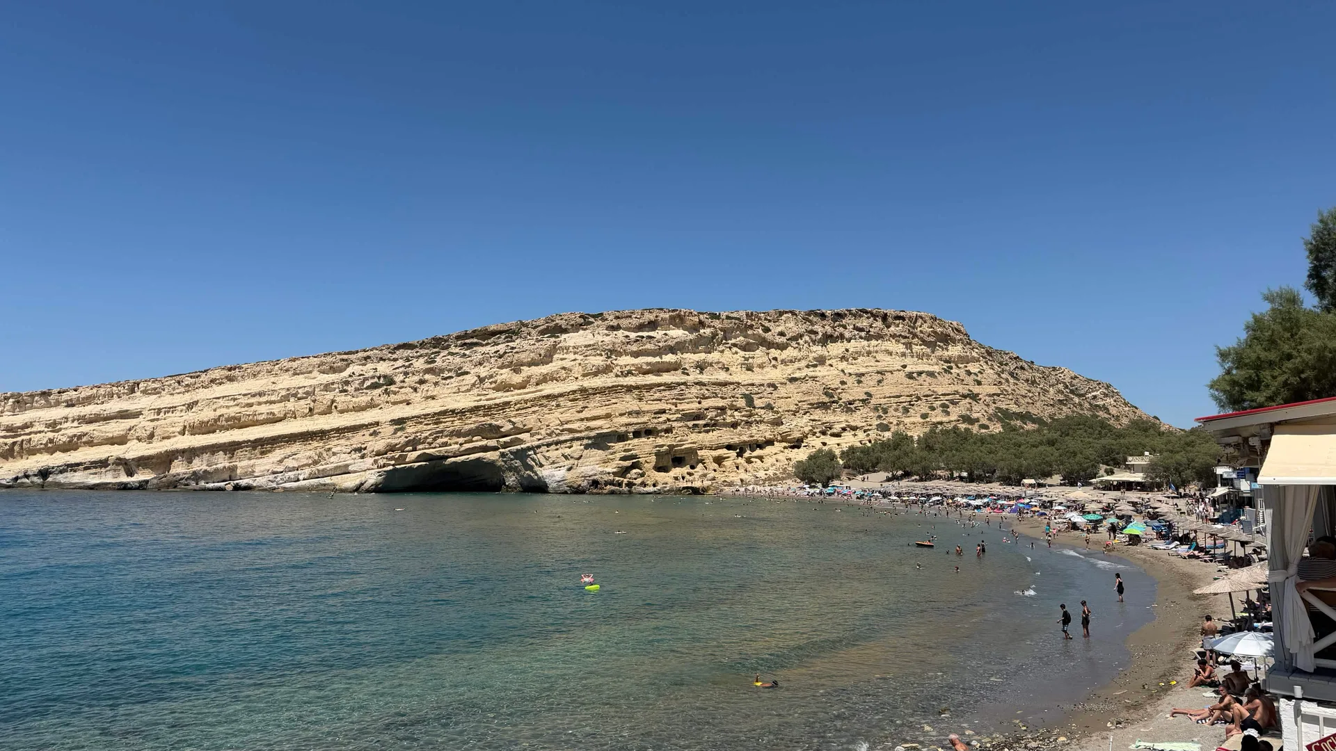 Matala bay and the cave-cut sandstone cliff above the beach