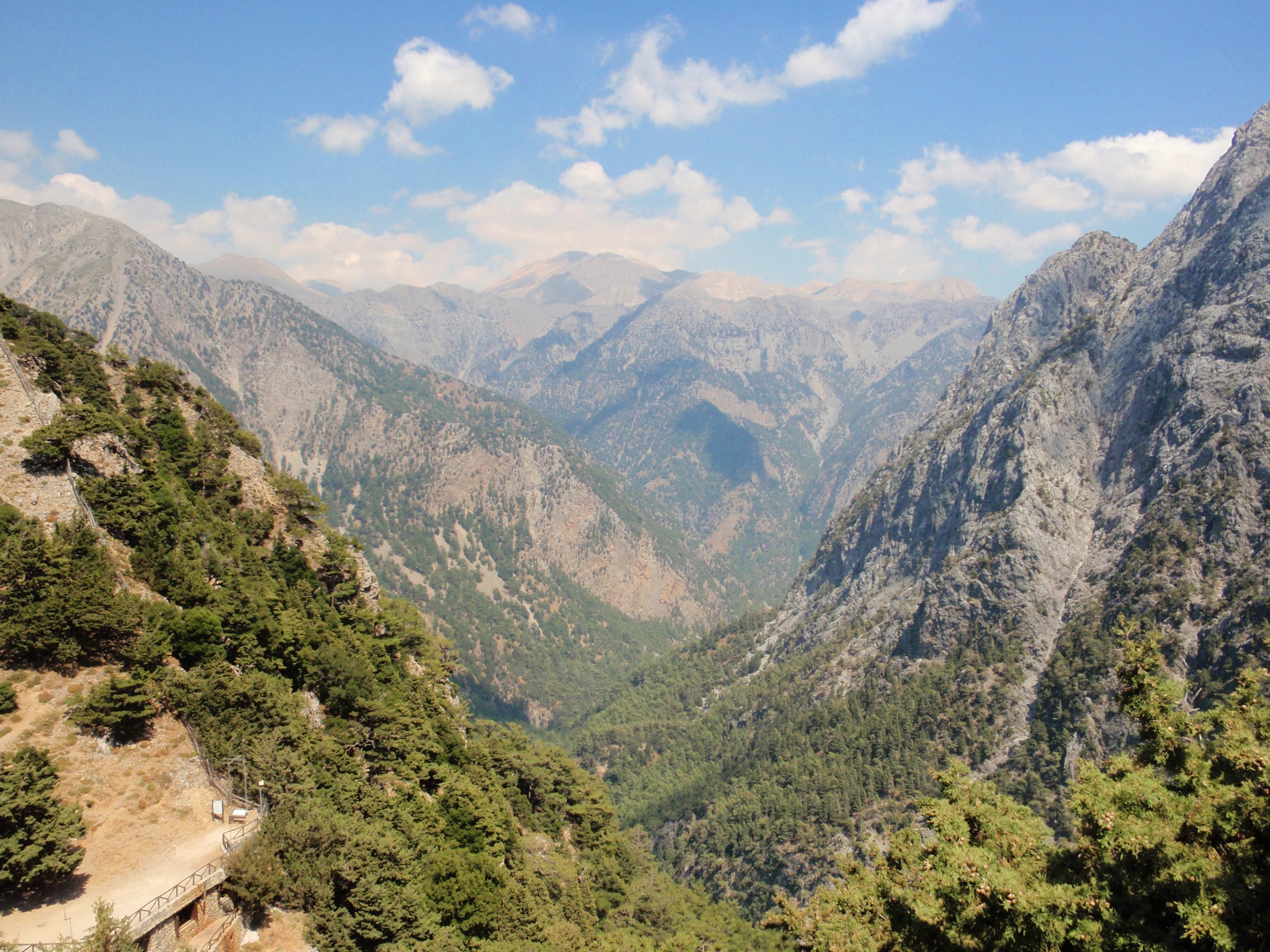 Walkers inside Samaria Gorge between high stone walls in Crete