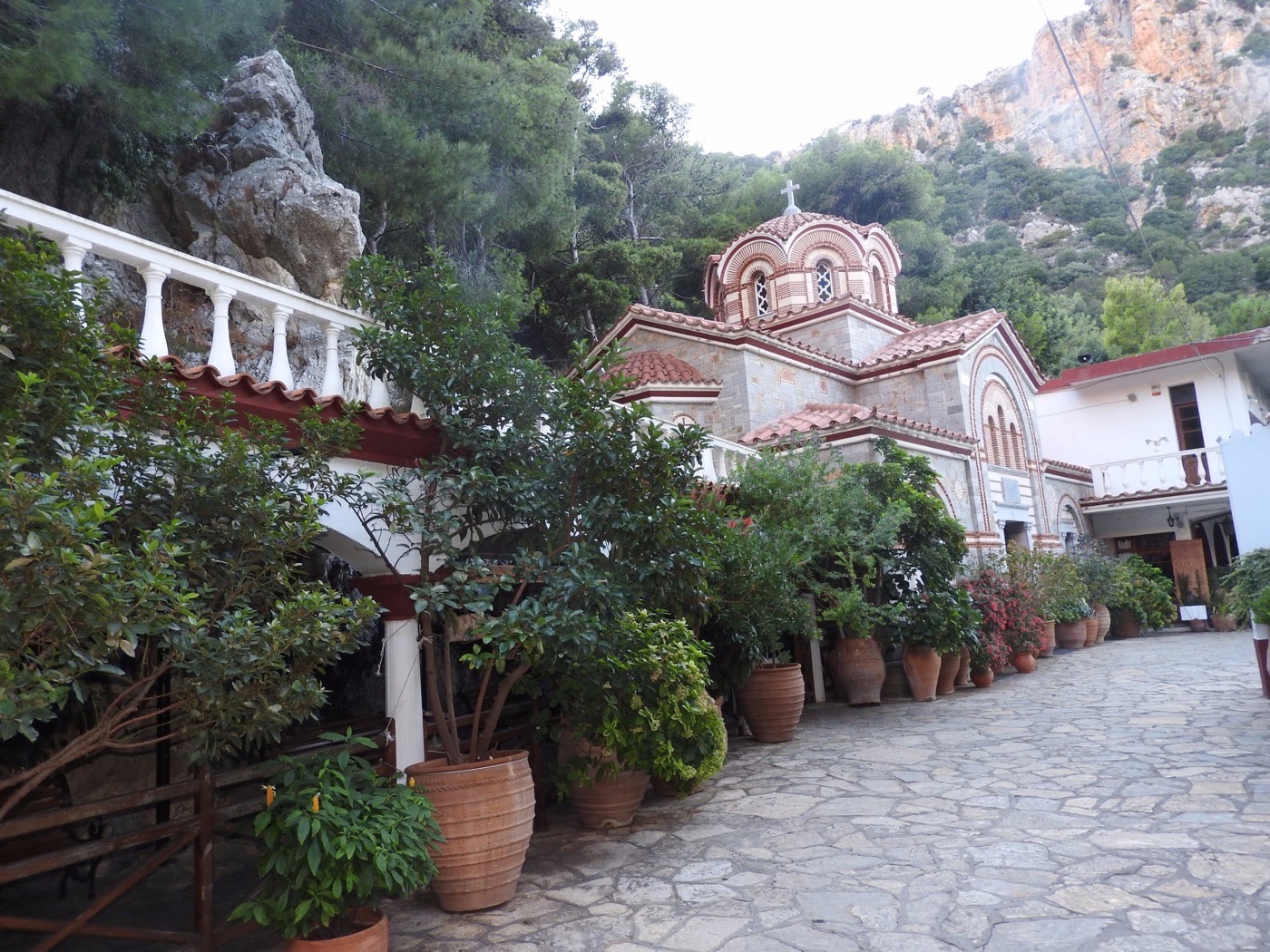 The monastery courtyard with terracotta pots and the church beyond