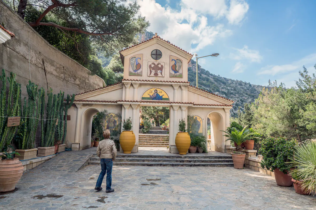 Stone buildings and arcades inside Agios Georgios Selinari Monastery